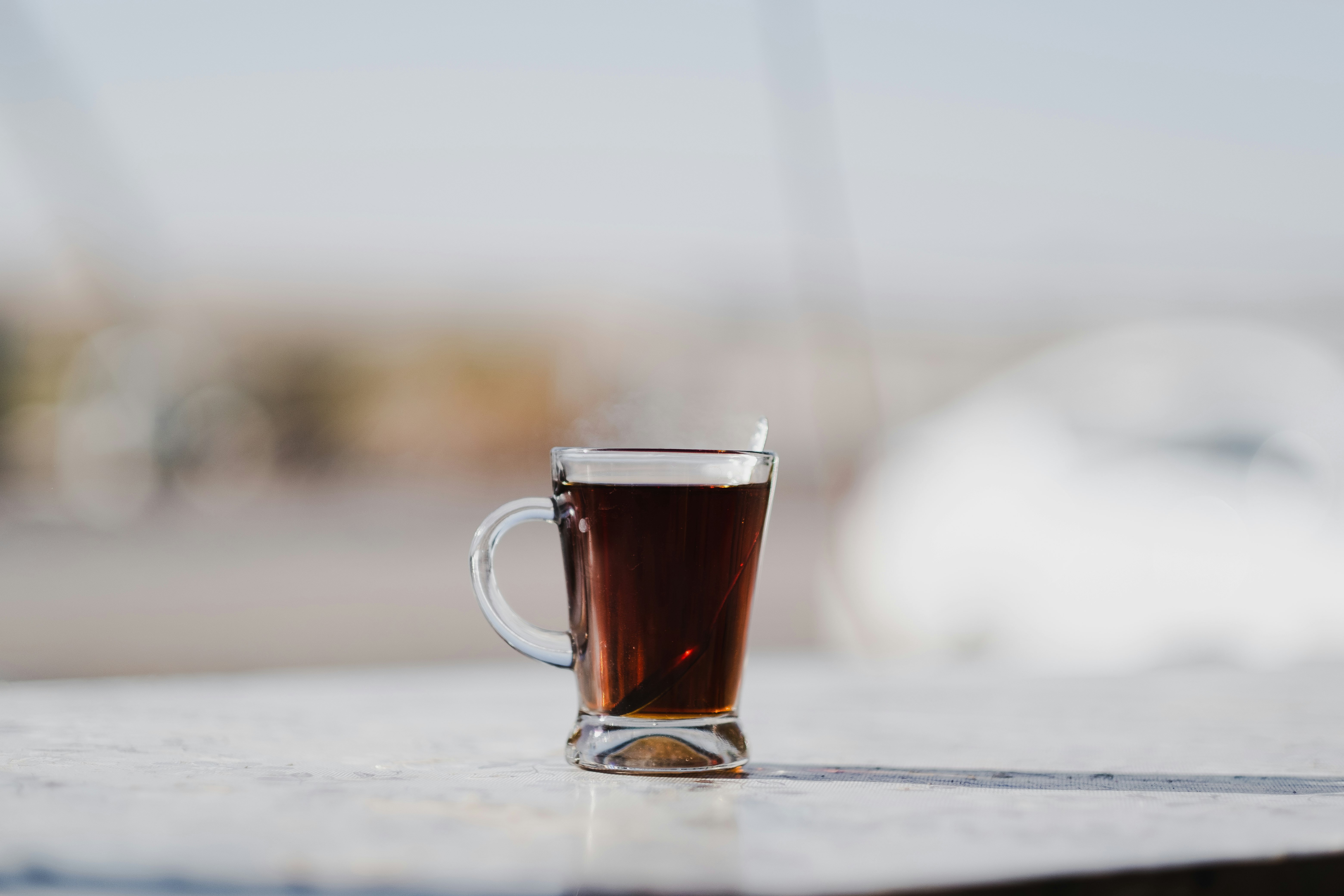 clear glass mug with brown liquid